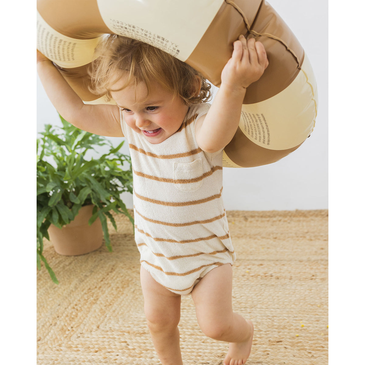 terry cloth romper with a round neck and wooden buttons for neck opening from búho for babies