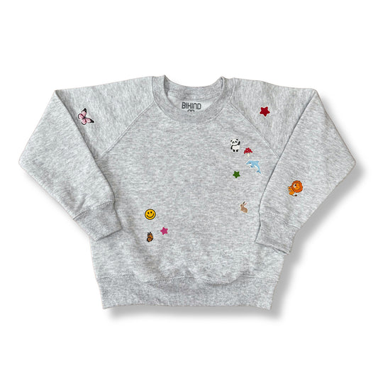 Heather grey sweatshirt with printed stickers from BIKIND on a white background