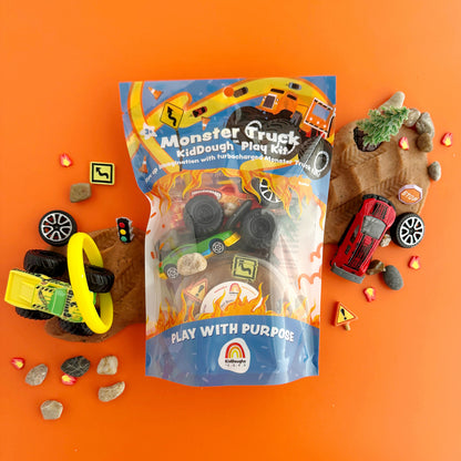 Earth Grown KidDoughs Monster Truck Kiddough Play Kit packaging on an orange background with toy trucks and other play pieces.