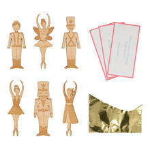 Load image into Gallery viewer, Meri Meri Nutcracker Character Medium Crackers with gold foil paper hats, jokes, and etched wooden Nutcracker character brooch, with a gold tone pin