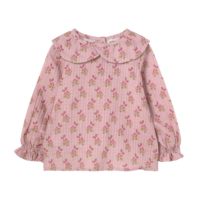Verona Blouse from Cozmo. Long-sleeved blouse in pink with all-over floral print. Smocked cuffs and a double-layered crossover collar.