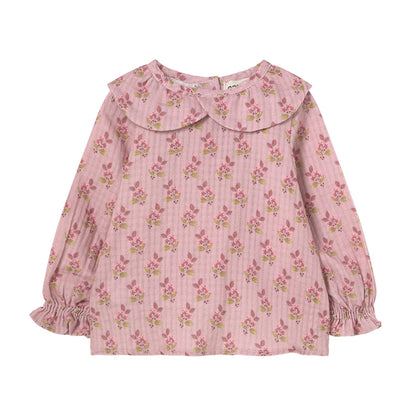 Verona Blouse from Cozmo. Long-sleeved blouse in pink with all-over floral print. Smocked cuffs and a double-layered crossover collar.