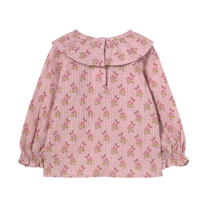 Verona Blouse from Cozmo. Long-sleeved blouse in pink with all-over floral print. Smocked cuffs, double-layered crossover collar and button closure at the back of the neck.