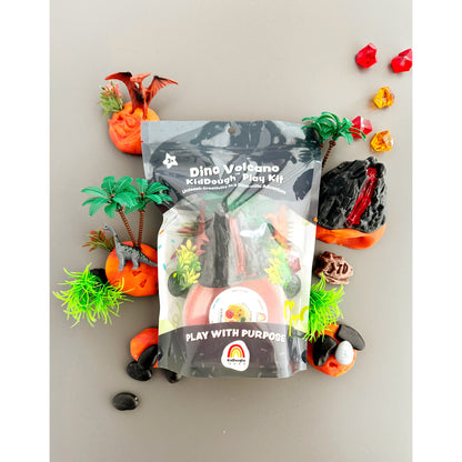 EGKD Dino Sensory KidDough Play Kit on a grey background with toy play pieces scattered around the packaging.