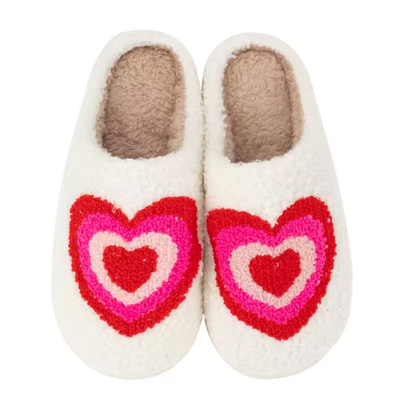 Pair of Malibu Sugar white slippers with pink and red heart designs on a white background