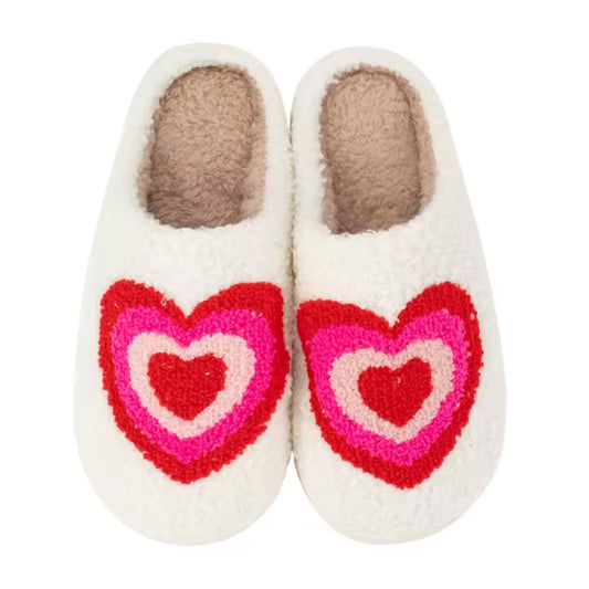 Pair of Malibu Sugar white slippers with pink and red heart designs on a white background
