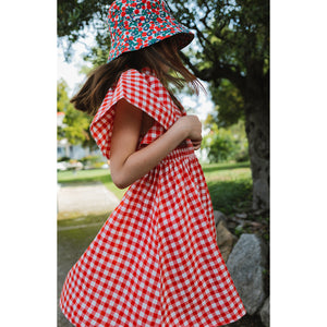 A Monday Eliya Dress in the colour poppy check for kids/children and tweens