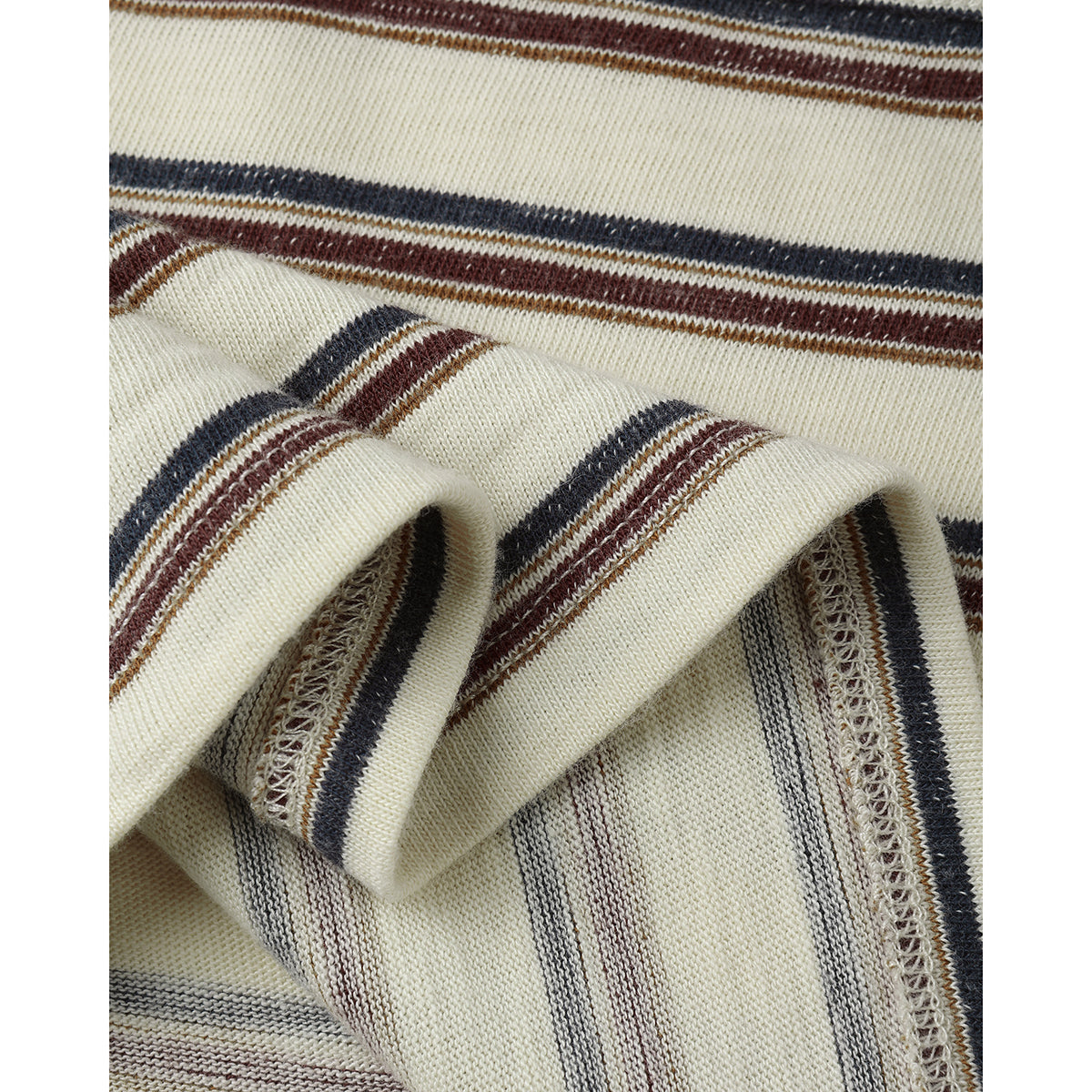 Close-up of Rylee + Cru's 'vintage stripe' print with muted blue and red/brown colours on a light beige/off white tee.