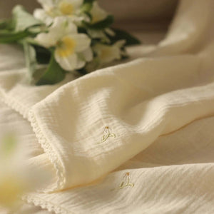 Embroidered floral four-layer Muslin blanket from avery row for newborns and babies