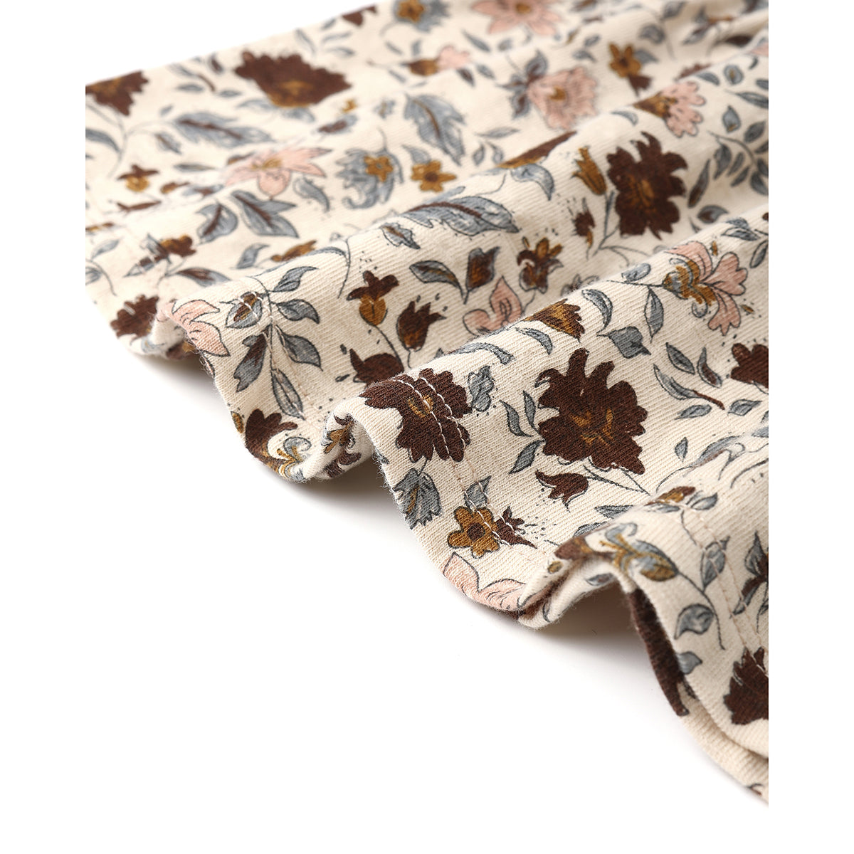Close-up picture of the fabric for a ruffled tiered midi skirt from Rylee + Cru with all-over floral print in muted red/brown, pink, yellow and blue colours on a light beige background