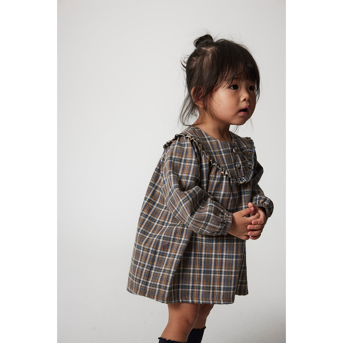 Cozmo Nuni Dress in a mixed plaid pattern  and long puffed sleeves for babies and toddlers