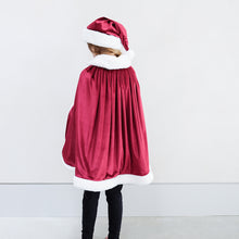 Load image into Gallery viewer, Mimi &amp; Lula Santa Cape with popper button closure with red grosgrain ribbon tie featuring padded silver star charms
