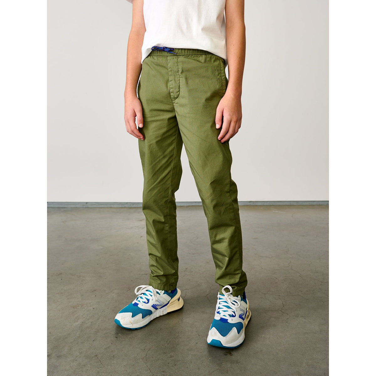 army green pharel trousers with tapered legs and elasticated waist and drawstring from bellerose for kids