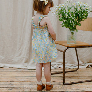 floral print Daisy Chain Dress with Shirred elastic rows around the top and ruffle detail from nellie quats for toddlers, kids/children