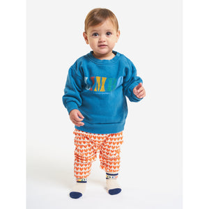 limbo front print on prussian blue sweatshirt with shoulder snap fastening, ribbed cuffs, ribbed bottom and a inner brush fleece from bobo choses for babies and toddlers