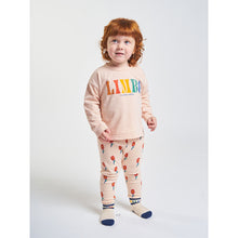 Load image into Gallery viewer, leggings in a peach colour with red flowers all over print from bobo choses for babies and toddlers