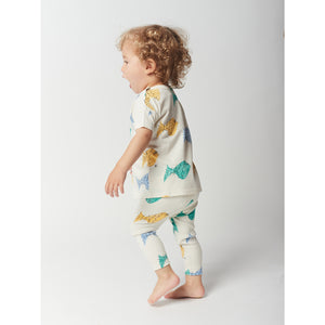 white t-shirt with green, yellow and blue fish all over print in a loose fit and with shoulder snaps from bobo choses for babies and toddlers