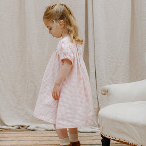soft pink check linen cat's cradle dress in the colour powder pink check from nellie quats for toddlers, kids/children