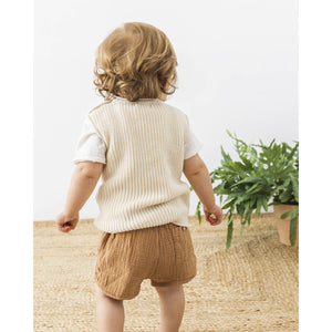 cotton muslin shorts in the colour caramel with a back pocket, decorative tie and elastic waist from búho for babies and toddlers