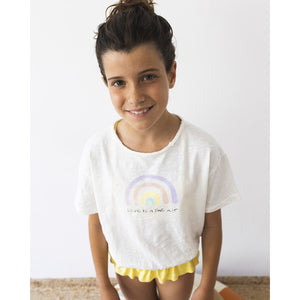 white short-sleeved T-Shirt with elasticated bottom and the front has a pastel rainbow print and the words 'love is in the air' print from búho for toddlers and kids/children